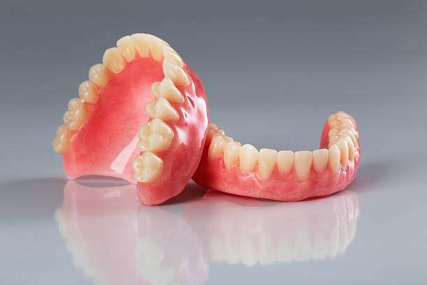 set of dentures A set of dentures on a shiny gray background human teeth photos stock pictures, royalty-free photos & images
