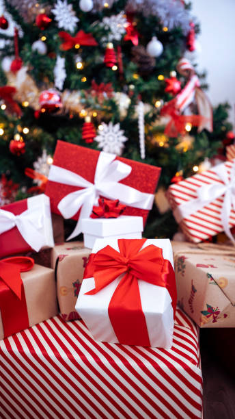 istock Beautiful wrapped gift boxes under a modern Christmas decoration tree home. Xmas 1797726887