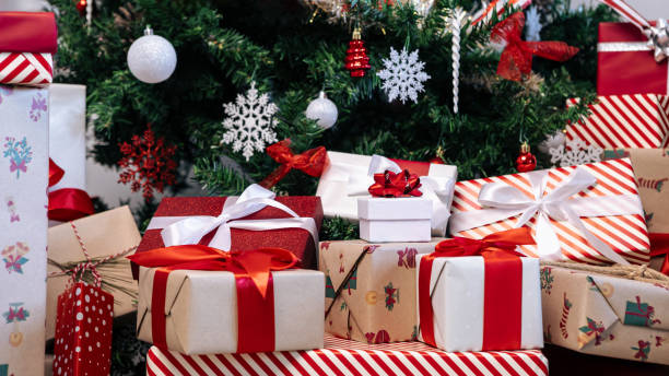 istock Beautiful wrapped gift boxes under a modern Christmas decoration tree home. Xmas 1797727009