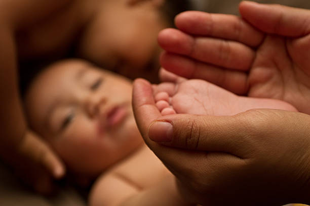 istock Baby feet closeup with mom holding him 179774822