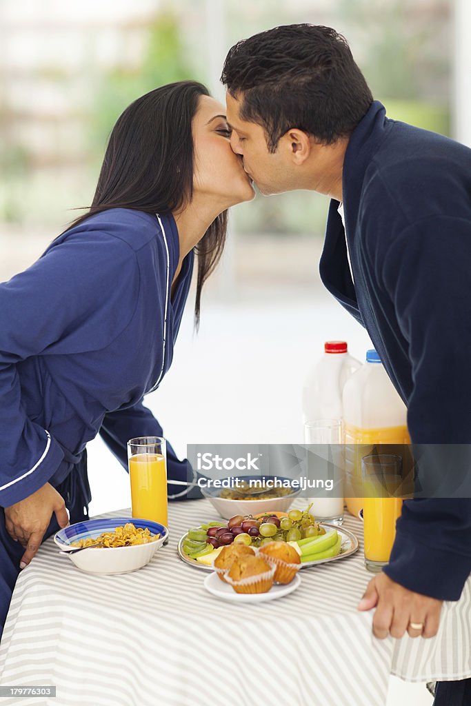 loving indian casal beijando sobre a mesa de café da manhã - Foto de stock de Adulto royalty-free