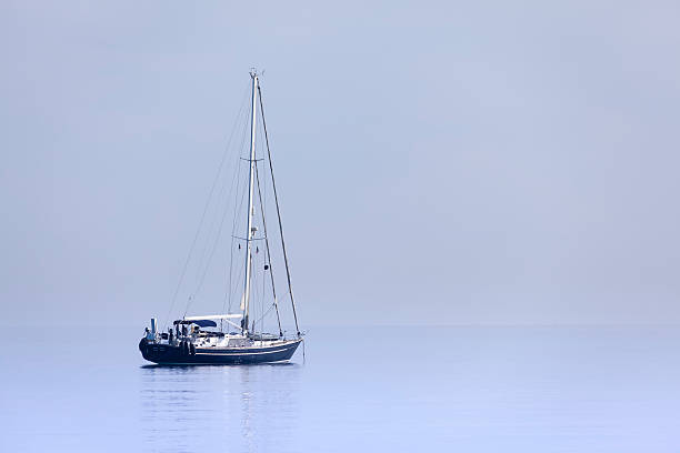 istock Lonely yacht in calm blue sea 179777113