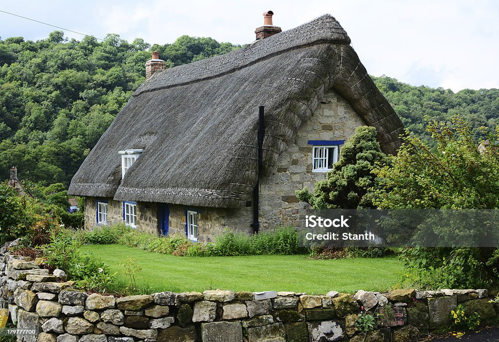 Thatched cottage in Yorkshire, England An old thatched cottage in a Yorkshire village, England Cottage Stock Photo