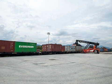 Ipoh, Perak Malaysia - December 5, 2022 : The activity of loading export containers onto wagons at the inland port or better known as Ipoh Cargo Terminal.