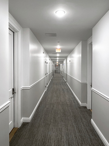 Looking at corridor of residential apartments with diminishing perspective