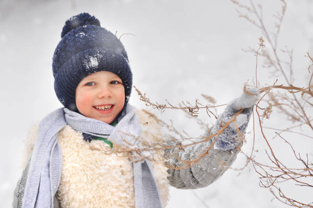 istock The boy is taking his teddy bear on a sledge to visit Santa Claus. 1797809781