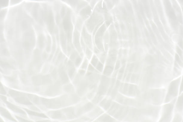 istock White water with ripples on the surface. Defocus blurred transparent white colored clear calm water surface texture with splashes and bubbles. Water waves with shining pattern texture background. 1797826740