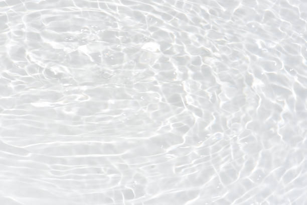 istock White water with ripples on the surface. Defocus blurred transparent white colored clear calm water surface texture with splashes and bubbles. Water waves with shining pattern texture background. 1797834788