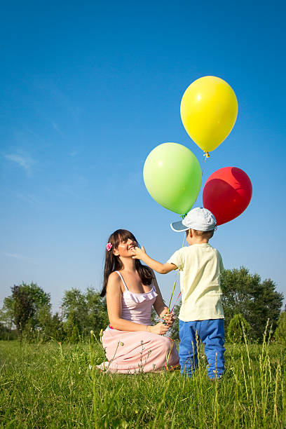 istock Mother and son playing with balloons 179783552