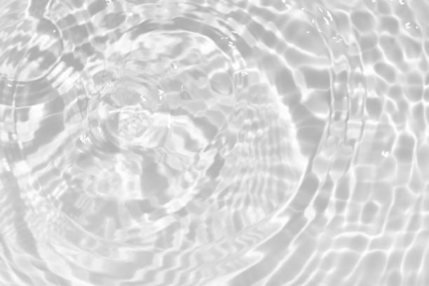 istock White water with ripples on the surface. Defocus blurred transparent white colored clear calm water surface texture with splashes and bubbles. Water waves with shining pattern texture background. 1797842283