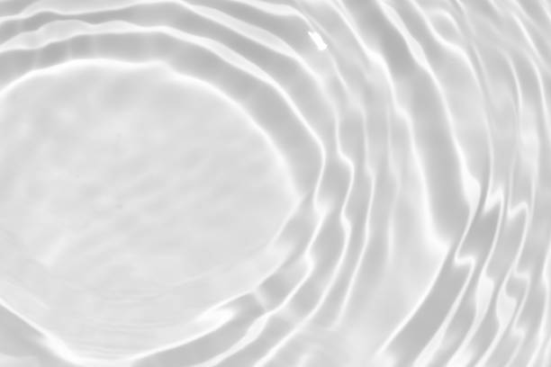 istock White water with ripples on the surface. Defocus blurred transparent white colored clear calm water surface texture with splashes and bubbles. Water waves with shining pattern texture background. 1797849084