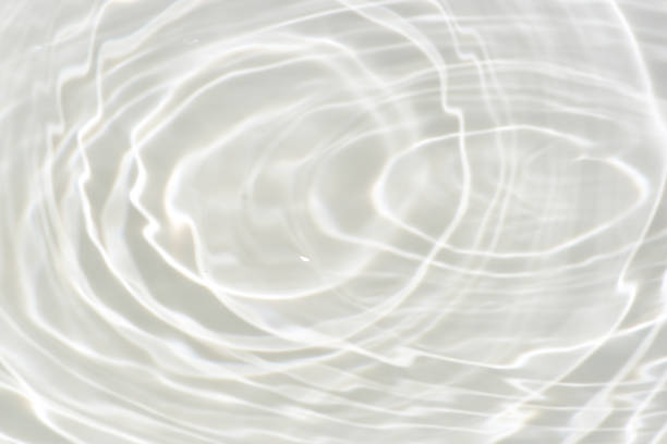 istock White water with ripples on the surface. Defocus blurred transparent white colored clear calm water surface texture with splashes and bubbles. Water waves with shining pattern texture background. 1797852199