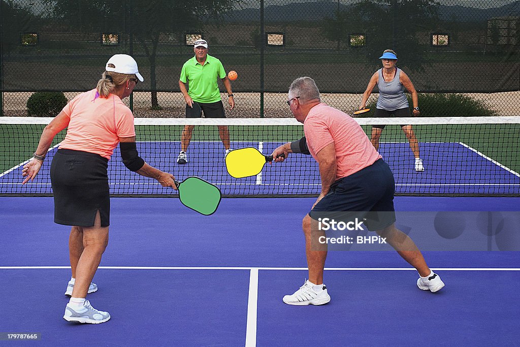 Two teams playing Pickleball Colorful image of two teams playing Pickleball in a mixed doubles format Pickleball Stock Photo