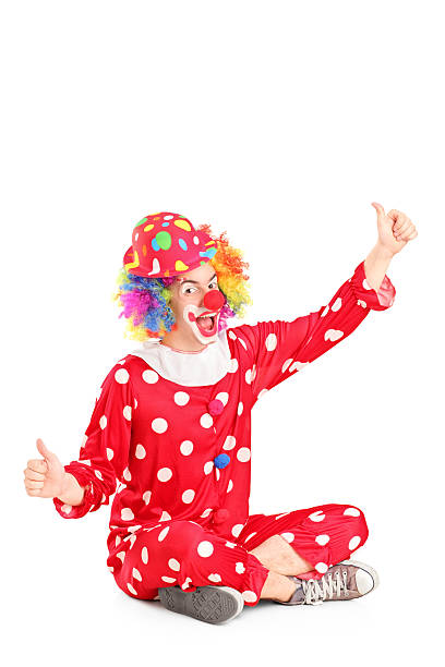 istock Funny circus clown sitting ang giving thumbs up 179789218