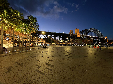 View of Circular Quay and the iconic Sydney harbor bridge. It is the sixth longest spanning-arch bridge in the world and the tallest steel arch bridge, measuring 134 m from top to water level, on Sydney harbor, Australia.
