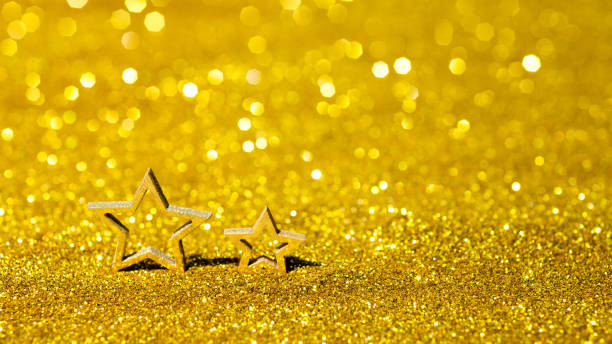 Christmas stars on shiny golden background.