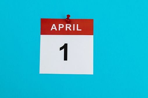April 1 calendar on blue background.