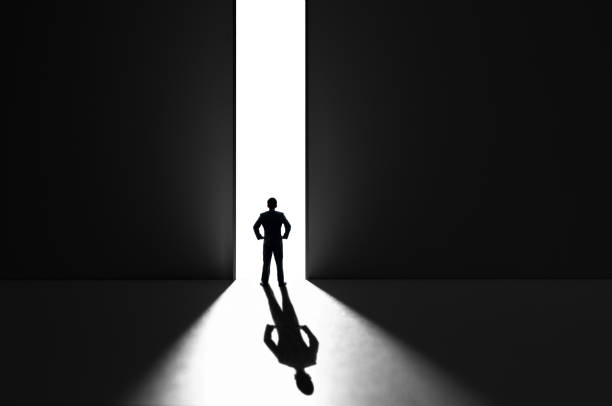 Businessman standing in front of open door