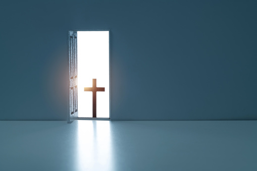 Open door with a religious cross