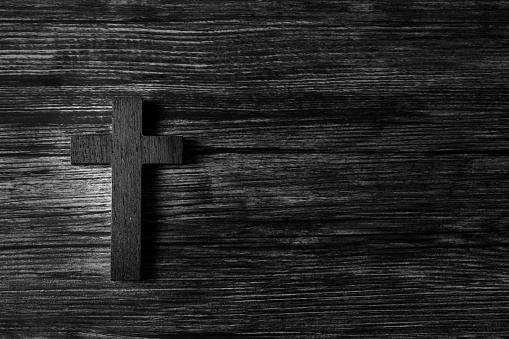 Religious cross on wooden background
