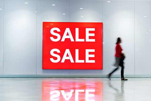 Sale sign on the wall of shopping mall