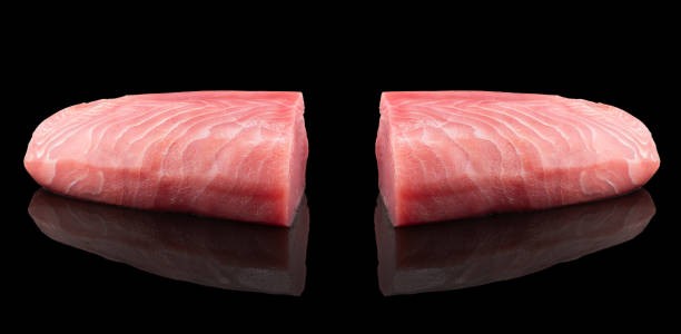 yellow fin tuna steak isolated on black background. fresh rare tuna steak isolated. raw yellowfin tuna fillet texture. background fresh fish meat. top view of slices of tuna meat. - tuna steak tuna prepared ahi meat imagens e fotografias de stock