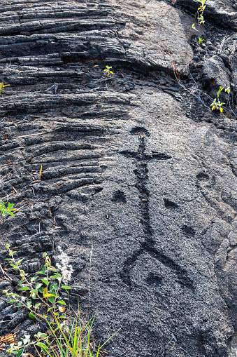 Pu'u Loa Petroglyphs, human stick figure and dots for umbilical cords worked into a Kīlauea volcano pāhoehoe lava flow. Hawaii Volcanoes National Park, Hawaii County, Hawaii, USA.