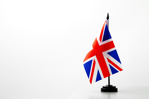 Flag of Great Britain Union Jack on flagpole studio shot close up