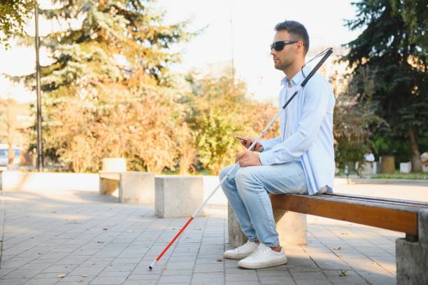 istock Blind man. Visually impaired man with walking stick, 1798001562
