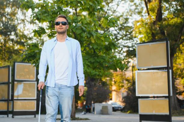 istock Blind man. Visually impaired man with walking stick, 1798004243