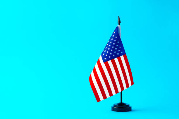 istock Small flag of USA on flagpole on studio background 1798005274