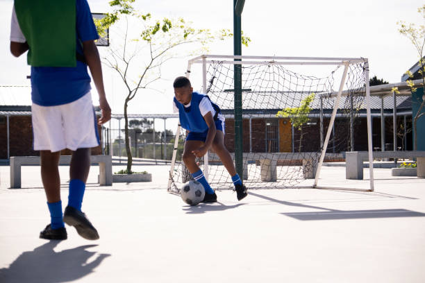 istock Schoolboys enjoy a friendly soccer game 1798032096