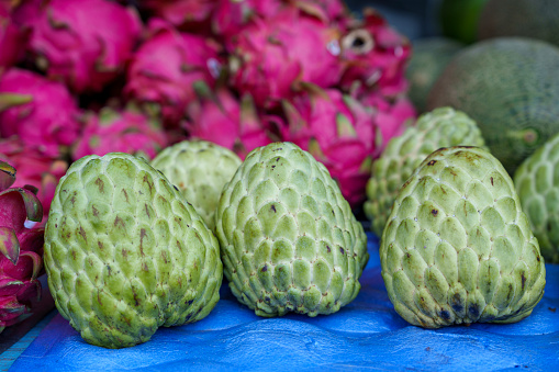 Soursop fruit displayed for sale at a market stall