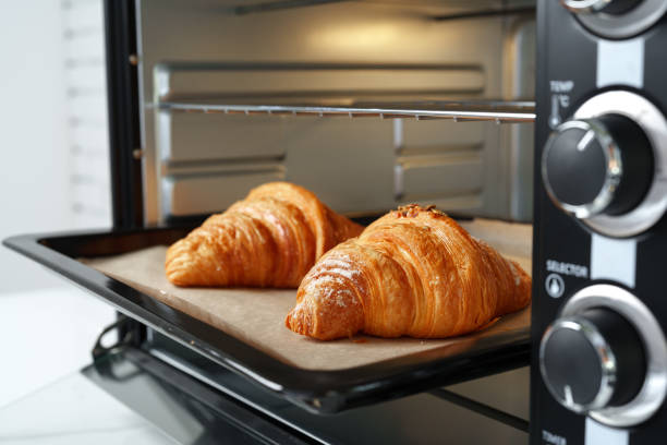 istock Modern mini electric oven with freshly baked croissants in kitchen 1798056737