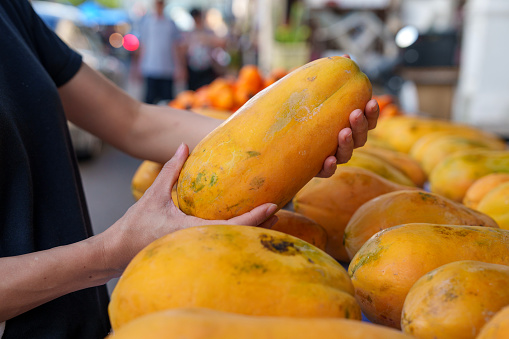 Fresh tropical papaya displayed for sale at a market stall