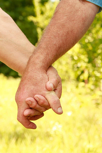 istock two hands of an elderly couple 179807743