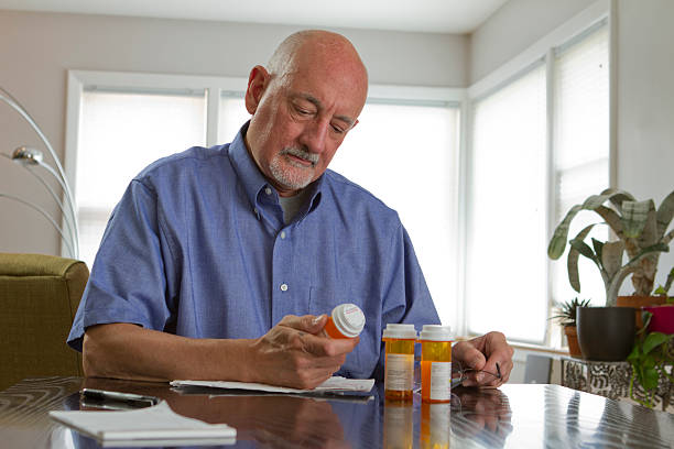 istock Older man with prescription medications 179812576