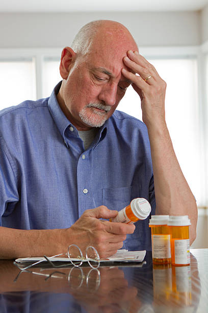 istock Older man with prescription bottles 179812580