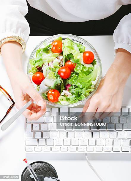 Woman Having A Salad Lunch Whilst Sat At Her Computer Stock Photo - Download Image Now
