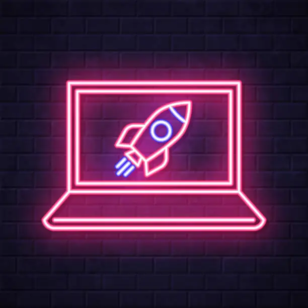 Vector illustration of Laptop with rocket. Glowing neon icon on brick wall background