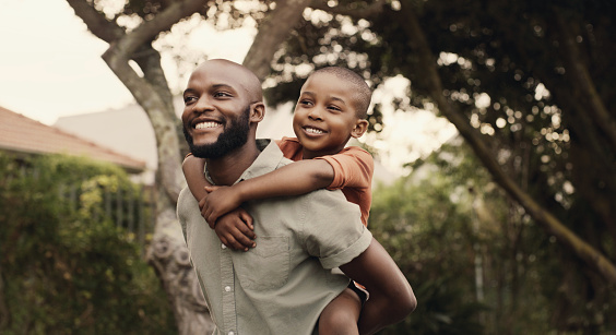 Happy, father and child piggyback in garden, backyard or walking in park with freedom and support. Black family, together and bonding in game outdoor in nature with love, happiness and energy