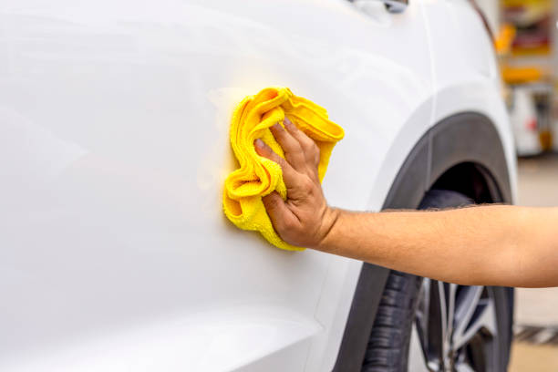 istock Man cleaning his car with a cloth 1798158113