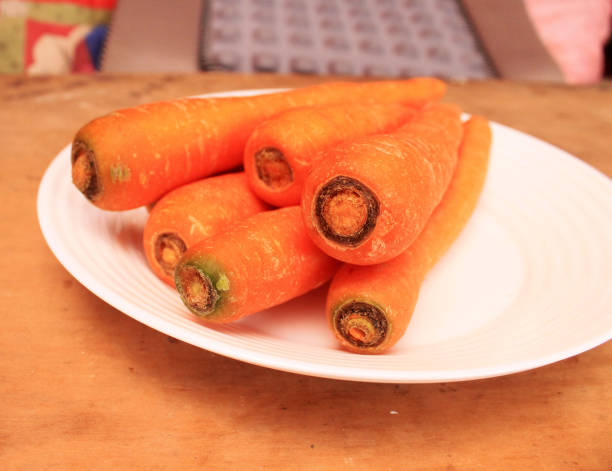 istock close up organic carrots on wood table 1798176156