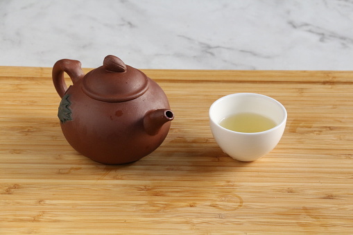 Various dry herbal tea, teapot and cup on wooden table. Top view flat lay