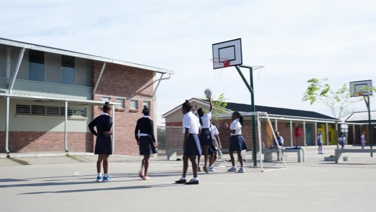 Girls have fun playing netball during break time