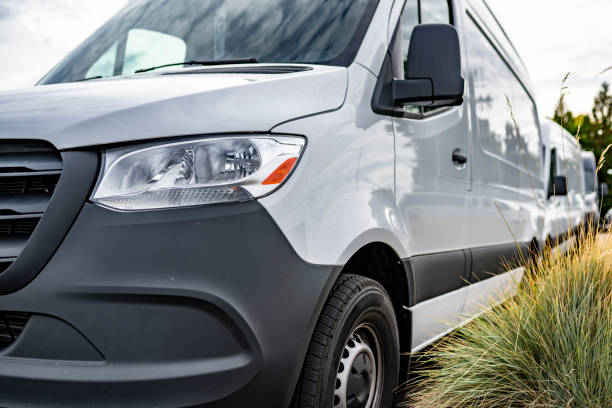 istock Front view of the compact cargo mini vans standing in line on the parking lot 1798201066
