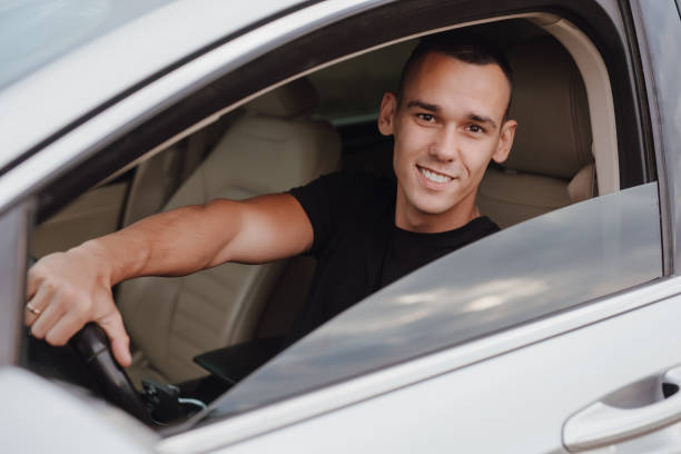 istock Happy young driver sitting in his car 1798218655