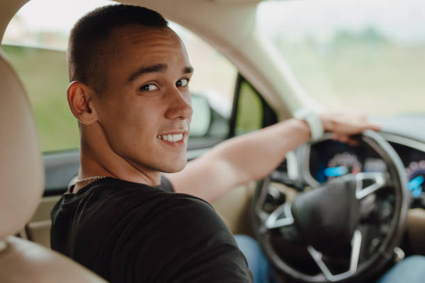 istock Happy young driver sitting in his car 1798219213