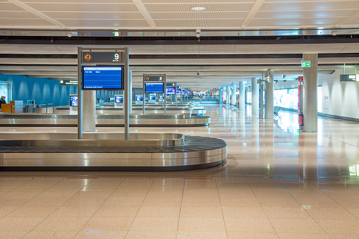 Hamburg, Germany - July 17, 2014: the baggae pick up area with baggabe belts at modern Hamburg airport.