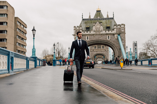 Young man in formal attire on a business trip in London, UK.